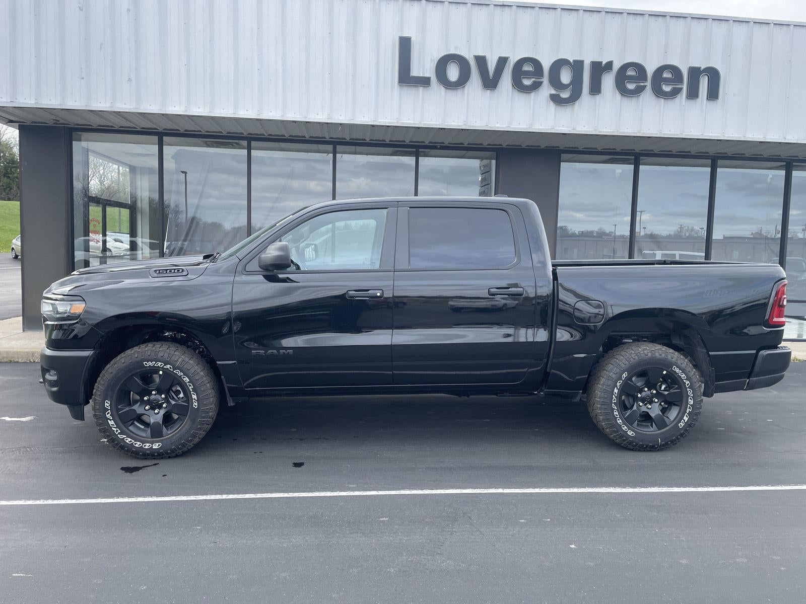 2026 RAM Ram 1500 RAM 1500 WARLOCK CREW CAB 4X4 5'7' BOX in Diamond Black Crystal Pearl-Coat Exterior Paint — front three-quarter view