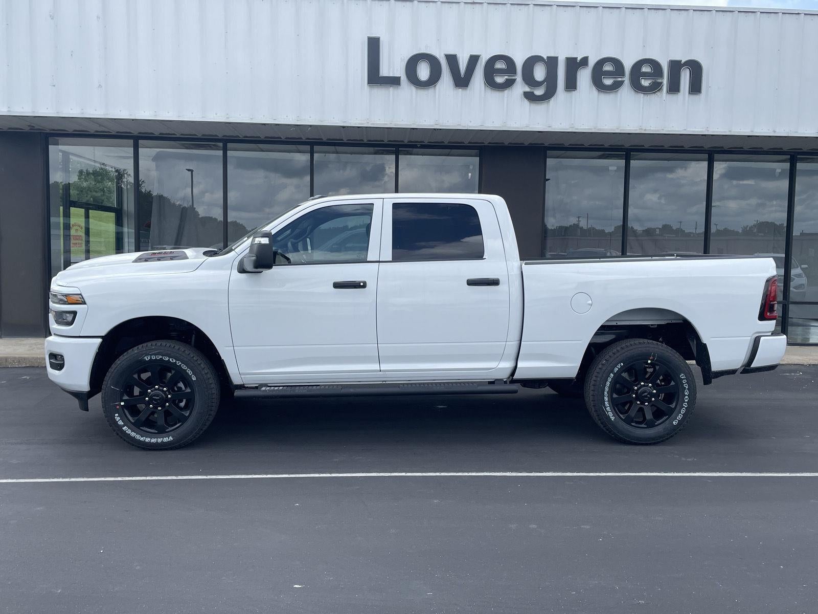 2026 RAM Ram 2500 RAM 2500 BLACK EXPRESS CREW CAB 4X4 6'4' BOX in Bright White Clear-Coat Exterior Paint — front three-quarter view